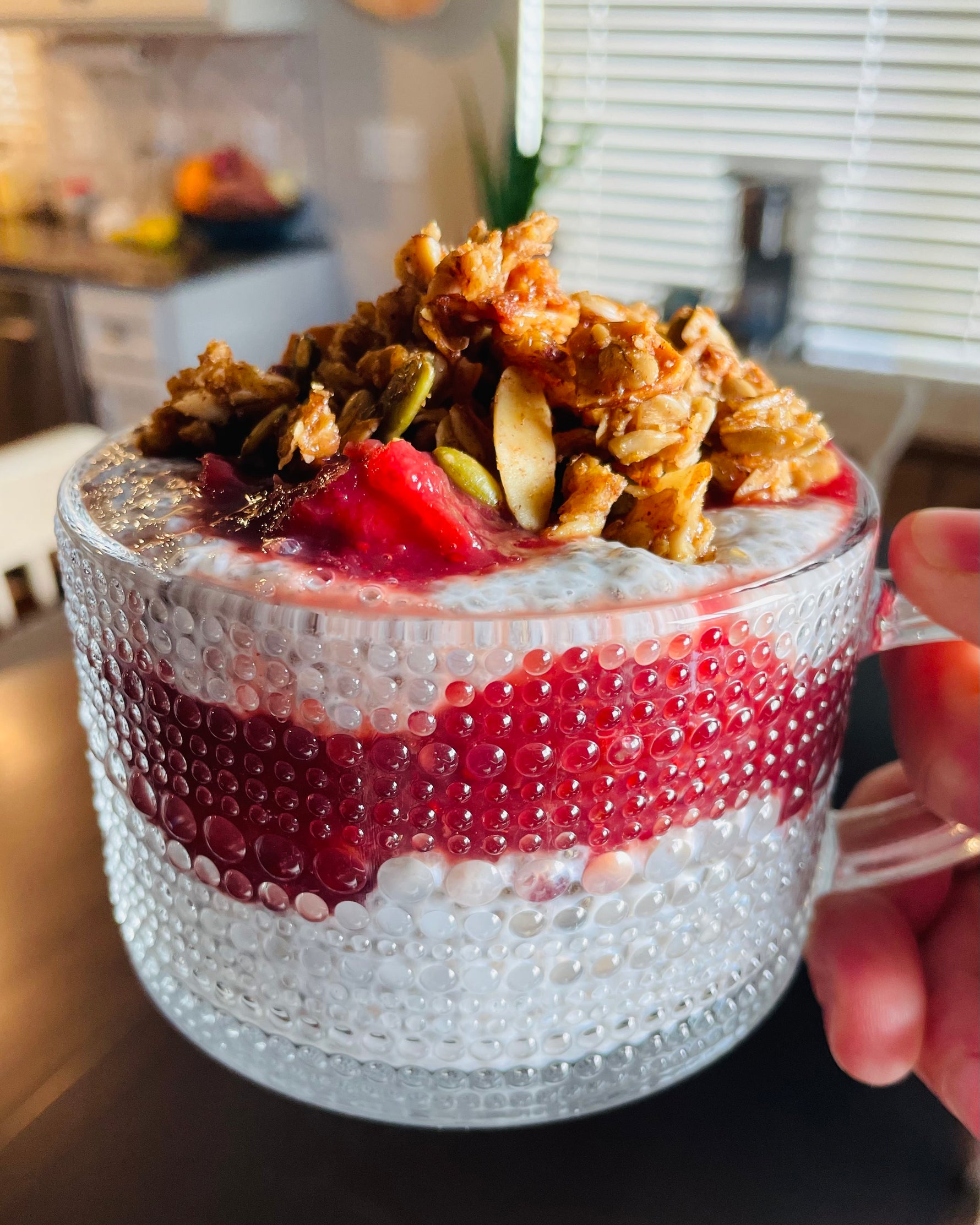 Chai Spiced granola layered in chia pudding parfait with cranberry compote