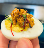 Savory granola served on deviled egg with microgreens